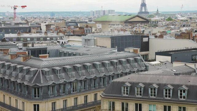 Panoramic top view of Paris, rooftops and the Eiffel Tower from the free observation deck on the roof of the Galeries Lafayette.