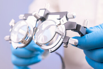 Cultural doctor with glasses to check vision in his hands. Optometers with tool for selection of...