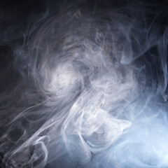 Abstract smoke texture over black background. Fog in the darkness.
