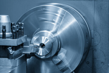 Closeup scene the lathe machine finish cut the metal parts in the light blue scene.