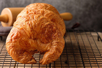 Freshly Baked Croissants on a Cooling Rack on a Wooden Table