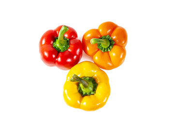 Fresh juicy shiny red, yellow and orange bell peppers. Isolated on white.