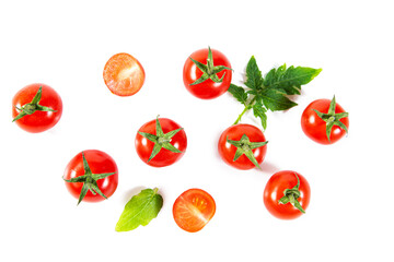 Fototapeta premium Ripe juicy cherry tomatoes and tomato slices with leaves.