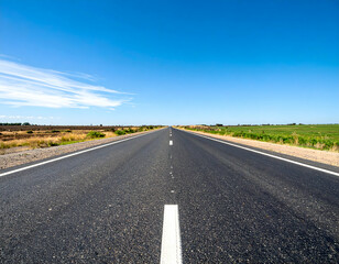Fototapeta premium Empty Country Road Under Blue Sky
