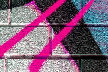 vivid street graffiti texture of colotful spray painting strips on gray metallic brick background, urban culture of modern youth backdrop