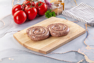 Raw meat pork and beef swirl sausages