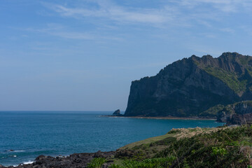 Jeju, South Korea, Umutgae Coast, Seongsan Ilchulbong, natural landscape, blue sky and ocean, volcanic cliff