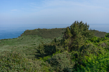 Seongsan Ilchulbong volcanic landscape, natural mood, overlooking lush greenery and ocean, Jeju, South Korea