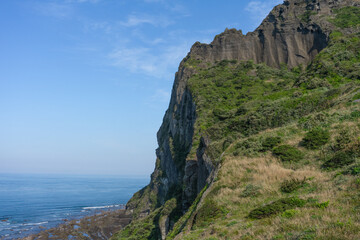 Jeju South Korea Seongsan Ilchulbong volcanic cliff landscape with copy space, coastal nature scene