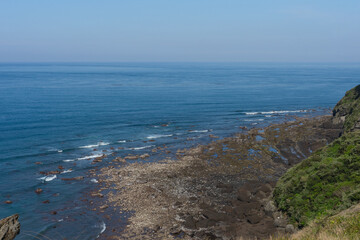 Rocky coastline landscape photo, natural blue tones, Jeju South Korea Seongsan Ilchulbong, ocean view