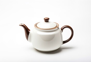 A white teapot sitting on top of a table.