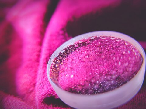 Fototapeta close up of a convex lens with water droplets on an insulated cloth