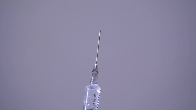 Close-up slow-motion shot of a syringe and needle, healthcare and epidemic prevention concept theme.