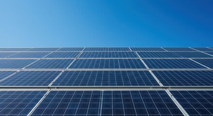 Solar panels against a clear blue sky generating clean renewable energy.