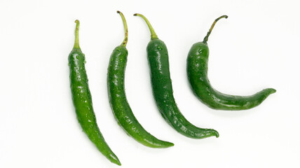 green hot chili peppers/ a group of green chili in white background