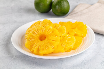 Sweet canned pineapple slices in syrope