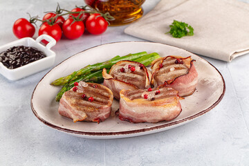 Tasty grilled pork medallion with bacon