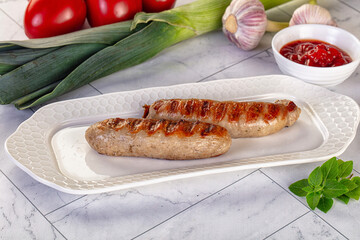 Grilled pork sausages served tomato sauce