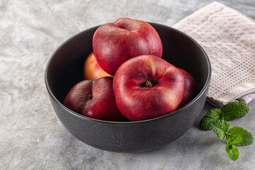 Ripe sweet juicy flat nectarines heap