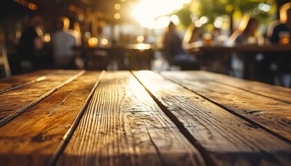 Fototapeta premium Wooden table in sunlight with blurred outdoor scene and people.