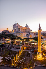 Magnificent sunset view of Trajans Column and the Altare della Patria in Rome. Ancient ruins and...
