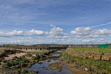 The Barry Burn wending its way through Carnoustie Links Golf Course with the old abandoned wooden Footbridge in the background.