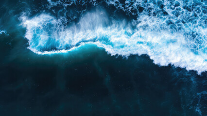 Aerial view of ocean waves crashing. Blue water texture background.