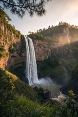 Fototapeta premium A tall waterfall cascades down a rocky cliff