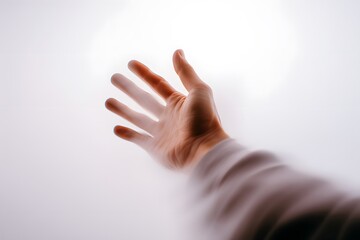 Obraz premium A human hand reaching upwards through a translucent barrier symbolizing hope aspiration and the quest for freedom in a minimalist setting