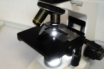 Close-up of a microscope in a laboratory, used for detailed scientific analysis.