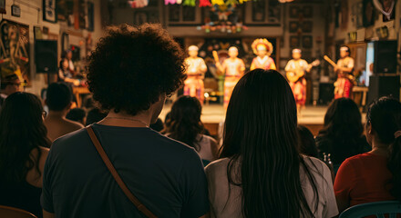 People watch a traditional cultural performance with costumes and music in a theater setting.