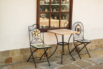 Tables and chairs in countryside street cafe on the terrace of an old house