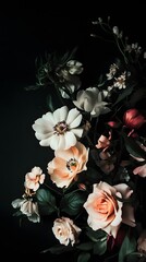 Darkly-lit floral arrangement of pastel blooms.