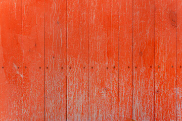 A fence of dirty red boards covered with stains and smudges. Natural decorative background.