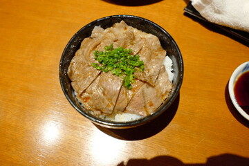 Delicious Bowl of Tender Beef on Rice Garnished with Fresh Chives Served in Traditional Japanese Cuisine Style
