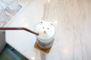 Delightful Coffee Drink with Cute Bear Foam Art in Glass on Marble Table