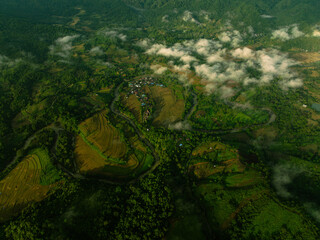 Small Village Hidden in Tropical Forest - Morning Aerial View