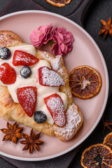 Food for breakfast sweet strawberry croissants with chocolate filling