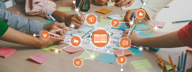 Creative business team brainstorming about marketing strategy and business plan by using mind mapping. Startup team work together to write down on paper. Focus on hand. Closeup. Variegated. Amity
