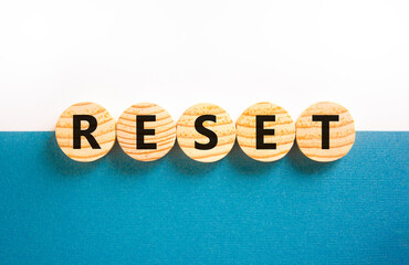 Reset symbol. Concept word Reset on beautiful wooden circles. Beautiful white and blue background....