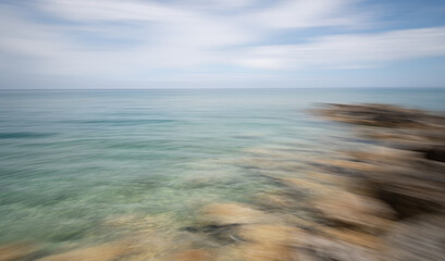 Blurred ocean horizon with dynamic sky movement