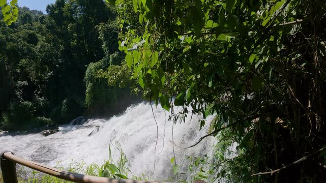 The Pha Dok Seaw Waterfall in Chiang Mai, Thailand, offers a serene view, with lush forest and flowing water enhancing the peaceful atmosphere.