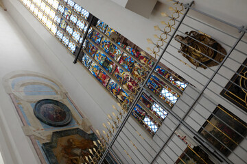 Elegant Interior View of Church with Stained Glass Windows, Religious Art, and Decorative Features