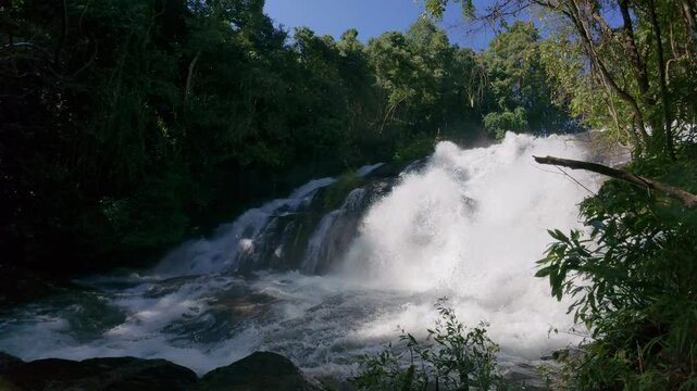 The Pha Dok Seaw Waterfall in Chiang Mai, Thailand, offers a serene view, with lush forest and flowing water enhancing the peaceful atmosphere.