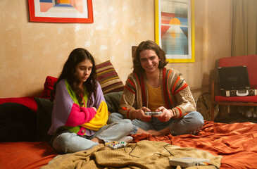 Two Friends Enthusiastically Playing Video Games on a Vintage Television