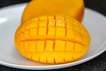 Ripe rosa mango isolated on uniform background. Brazilian fruit and food