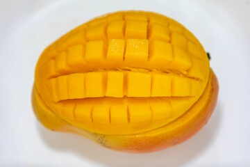 Ripe rosa mango isolated on uniform background. Brazilian fruit and food