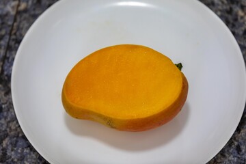 Ripe rosa mango isolated on uniform background. Brazilian fruit and food