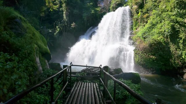 The Pha Dok Seaw Waterfall in Chiang Mai, Thailand, offers a serene view, with lush forest and flowing water enhancing the peaceful atmosphere.