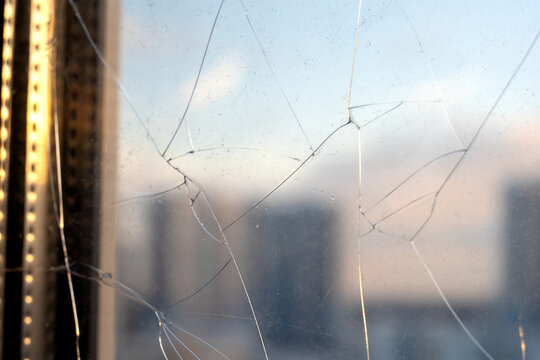 Cracked window glass in a town house.Replacement of the double-glazed unit.Removing a broken window.